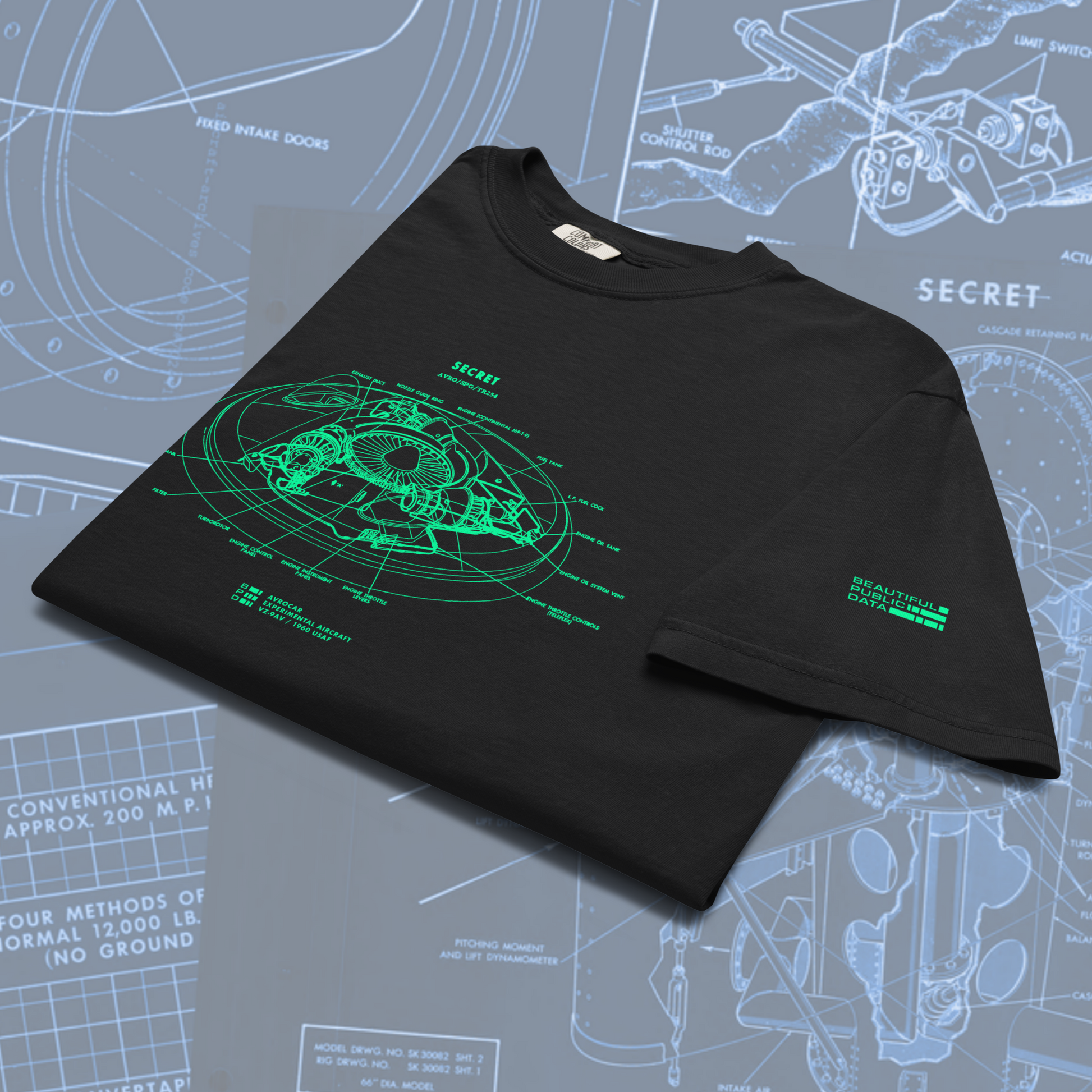Black t-shirt with green graphic design on a technical drawing background